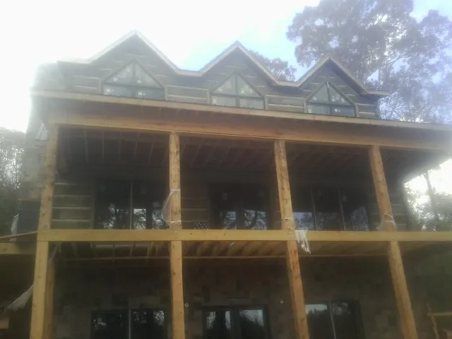 Dormers and porch framing on a large log home under construction in Lemoyne