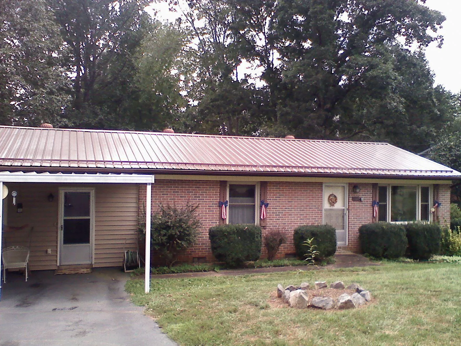 Bronze metal roof and carport on a brick ranch home — Roof Repair work by our crew in Lemoyne