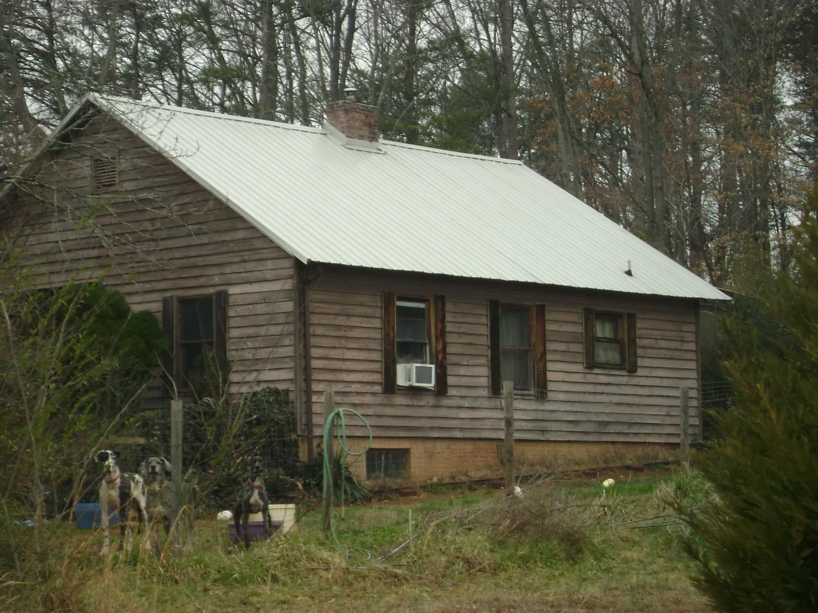 White metal roof on an old wood sided farmhouse, from a Metal Roof Installation job in Lemoyne